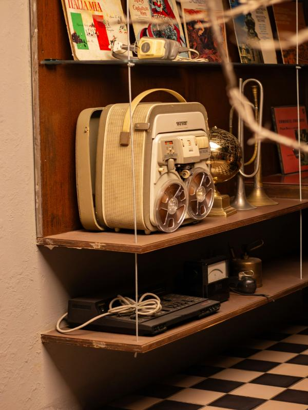 collection of antique radios and rotary phones vintage shelf