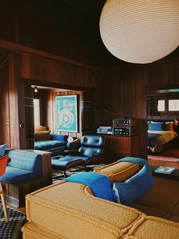 wood panel room with blue couch retro interior design